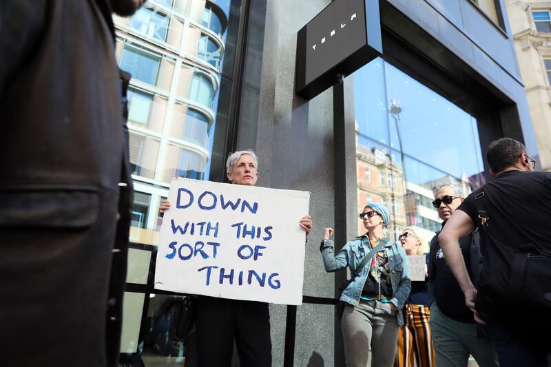 A protester hold a Father Ted-themed placard at a rally outside the Tesla outlet on Oxford Street in London on Saturday. Photograph: Alishia Abodunde/Getty Images
