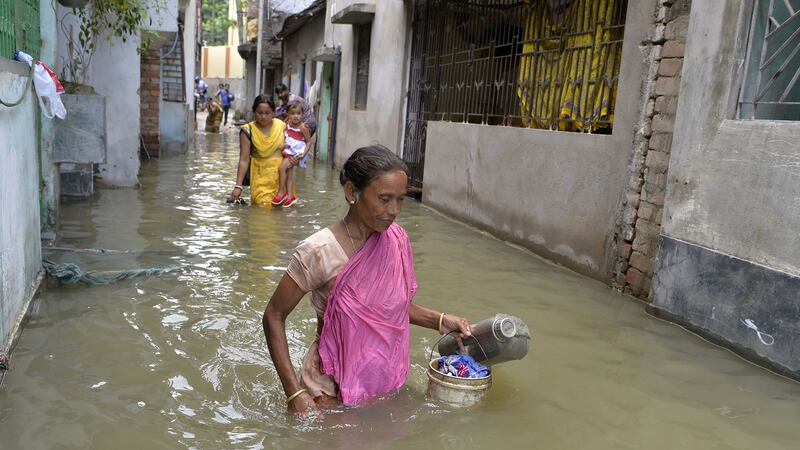 Indian residents walk through flood waters in Malda in the Indian state of West Bengal on August 24th. Photograph: Diptendu Dutta/AFP/Getty Images
