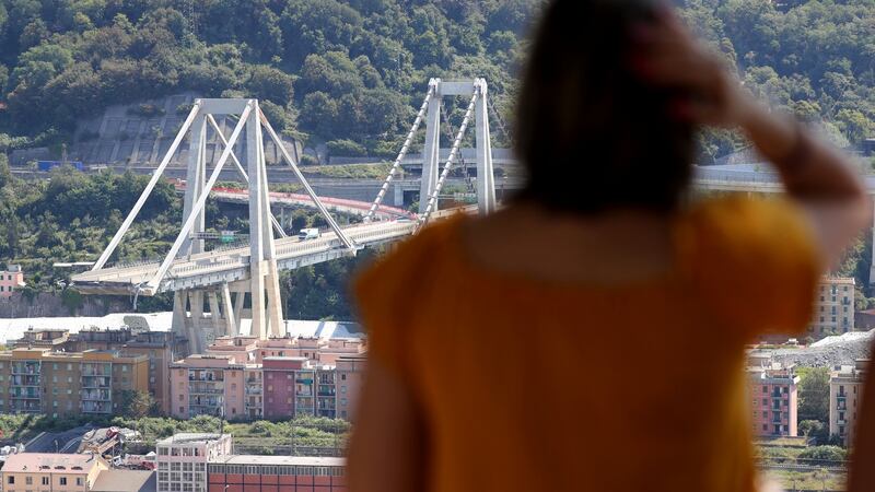 A woman looks at the collapsed Morandi Bridge, in the port city of Genoa. Photograph: Stefano Rellandini/Reuters