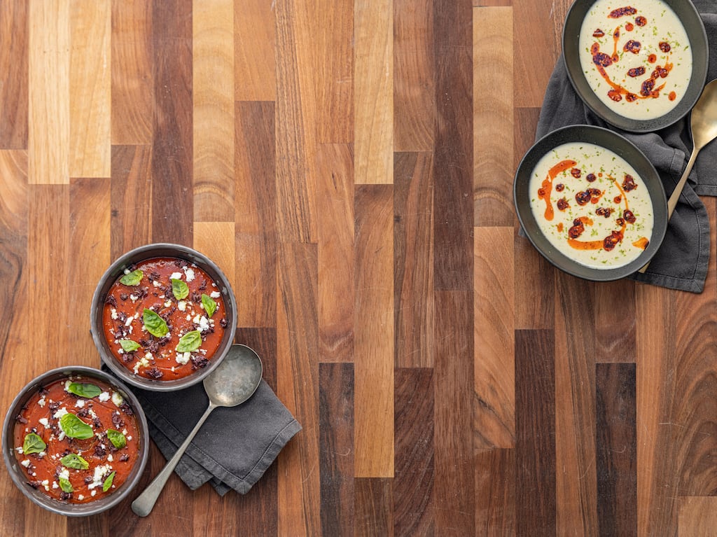 Chilled gazpacho with black olive, basil and feta; and spiced coconut and cauliflower soup with peanut and chilli rayu. Photograph: Harry Weir