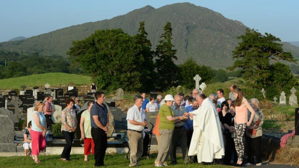 Fr Martin Sheehan distributing Communion at the annual Kilmakilloge pattern Mass. Photograph: Frank Miller
