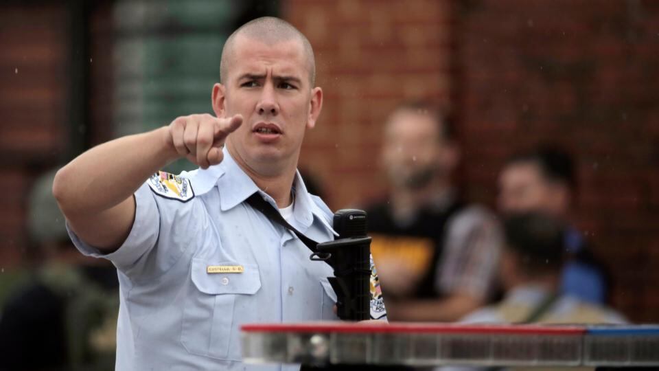 A police officer moves bystanders back from the scene of the shooting at the Washington Navy Yard in Washington today. Photograph: Jason Reed/Reuters
