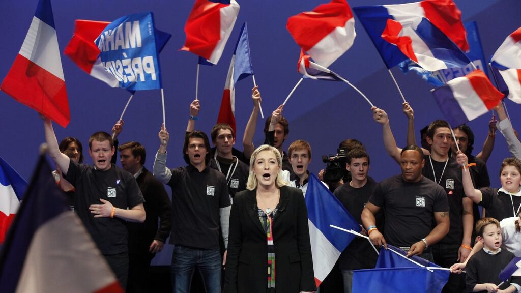 France’s National Front party president Marine Le Pen sings the French national anthem. Photograph: Pascal Rossignol/Reuters