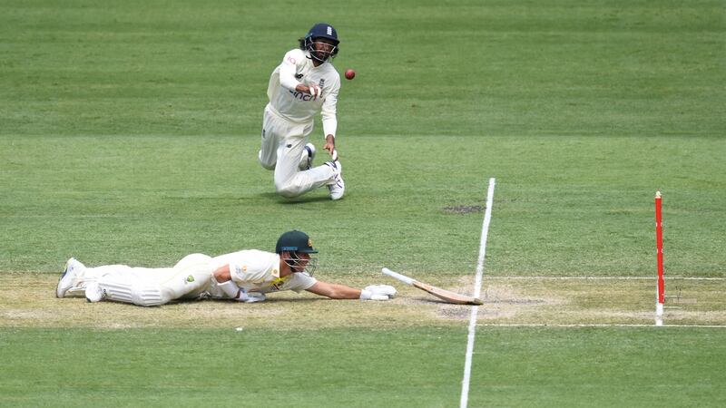 David Warner loses control of his bat as Haseeb Hameed misses the stumps. Photo: Darren England/EPA