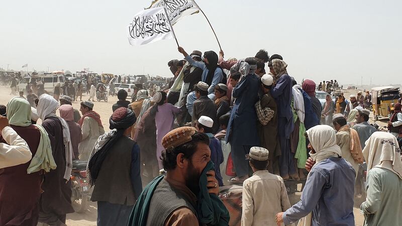 People wave Taliban flags as they drive through the Pakistani border town of Chaman on Wednesday. Photograph: Asghar Achakzai/AFP via Getty Images