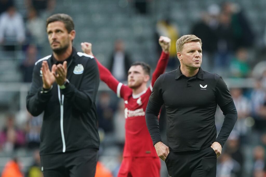 Newcastle manager Eddie Howe and his assistant Jason Tindall (left) look dejected after 10-man Liverpool fight back to win at St James' Park. Photograph: Owen Humphreys/PA Wire