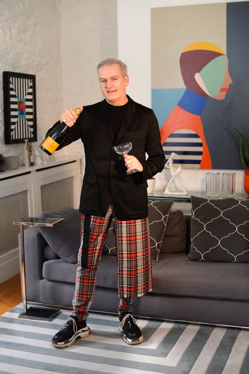 John Redmond, in his party wear at home with some of his paintings in Churchtown, Dublin. Photograph: Dara Mac Donaill