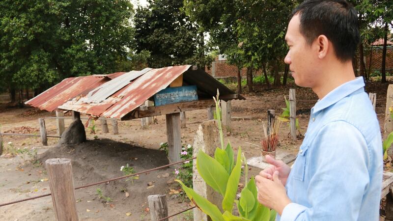 Ly-Sok Kheang of the Documentation Centre of Cambodia, and director of the Anlong Veng Peace Centre, at the grave of Pol Pot in Anlong Veng, northern Cambodia. Photograph: Nevenka Lukin