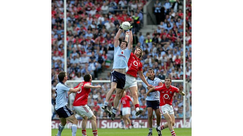 Dublin's Michael Dara Macauley claims a high ball ahead of Cork's Aidan Walsh at Croke Park during the 2010 All-Ireland SFC semi-final. - (Photograph: Ryan Byrne/INPHO)