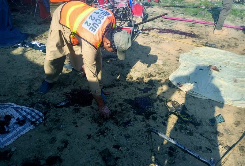 Rescue workers inspect the site after a bomb explosion in the Bajaur district, Pakistan. The provincial police chief Akhtar Hayat confirmed the explosion was caused by a suicide bomb. Photograph: AP