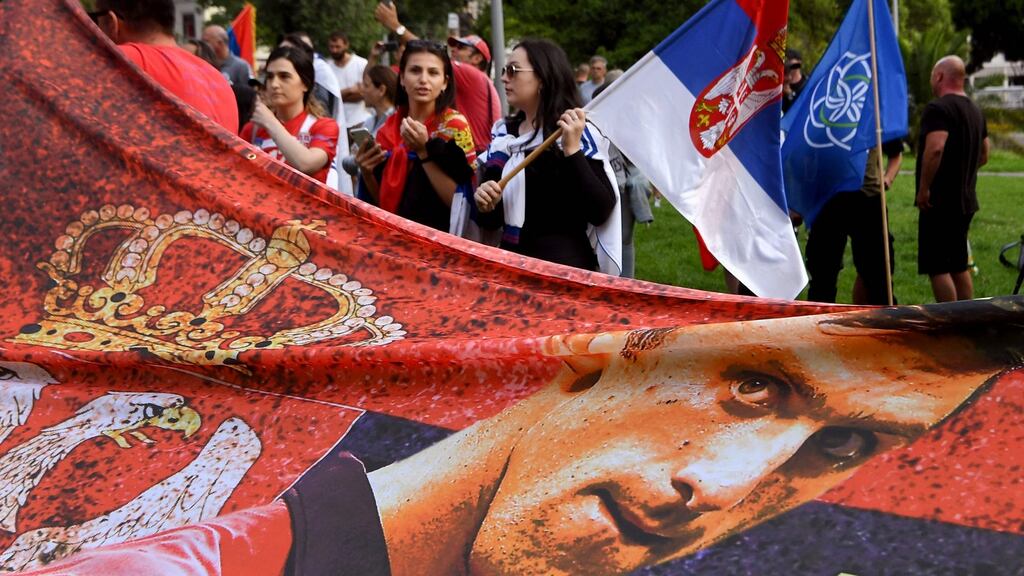 Members of the local Serbian community hold flags and banners outside a government detention centre where Serbia’s tennis champion Novak Djokovic is staying in Melbourne. Photograph: William West/AFP via Getty Images