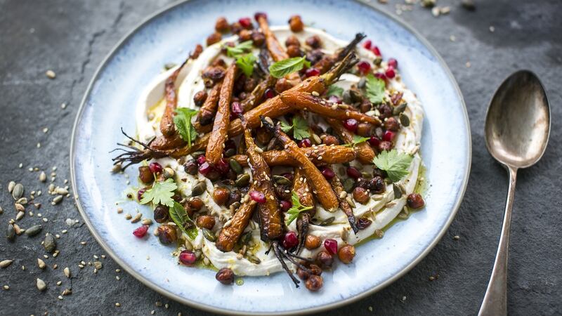 Sticky roast carrots and chickpeas with taghourt, pomegranate and toasted seeds. Photograph: Donal Skehan