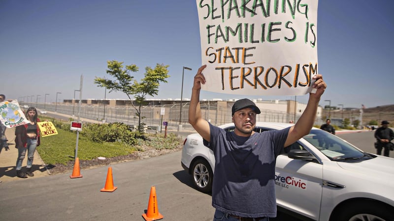 A protester display a sign while participating in a demonstration against immigration enforcement officials separating undocumented families at the Otay Mesa Detention facility in Otay Mesa, California on June 10th. Photograph: Sandy Huffaker/AFP
