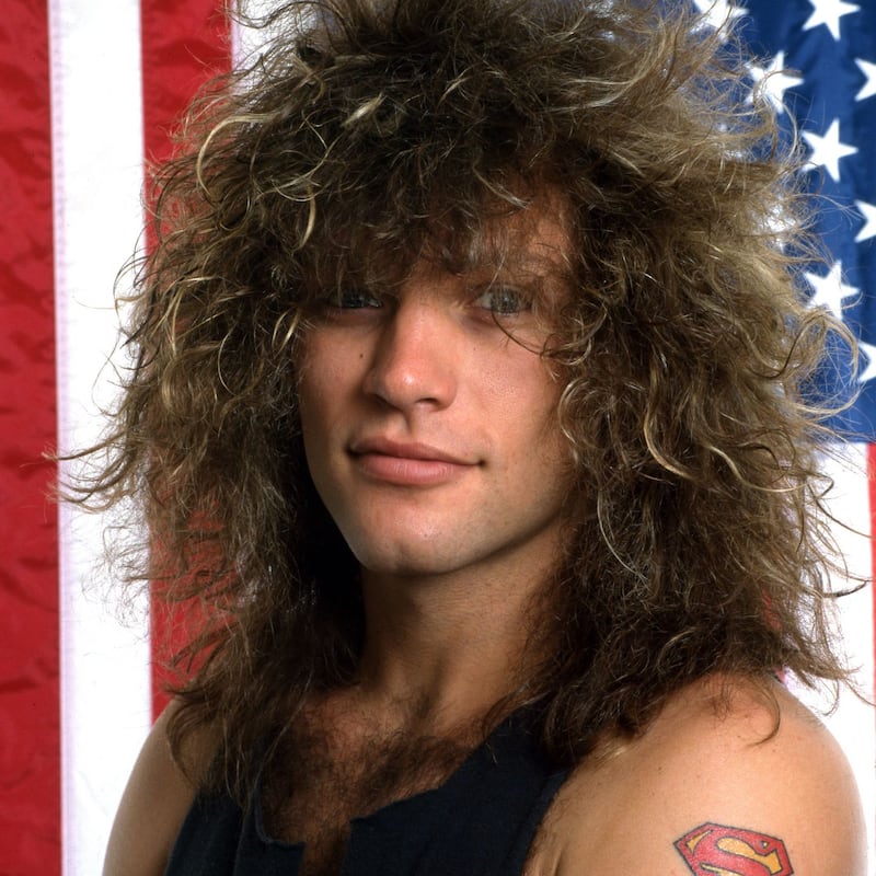 DETROIT - JUNE 1985: American singer-songwriter, actor and namesake of the rock band Bon Jovi poses for a portrait in front of the American flag, June, 1985, in Detroit, MI. Photograph: Ross Marino/Getty Images