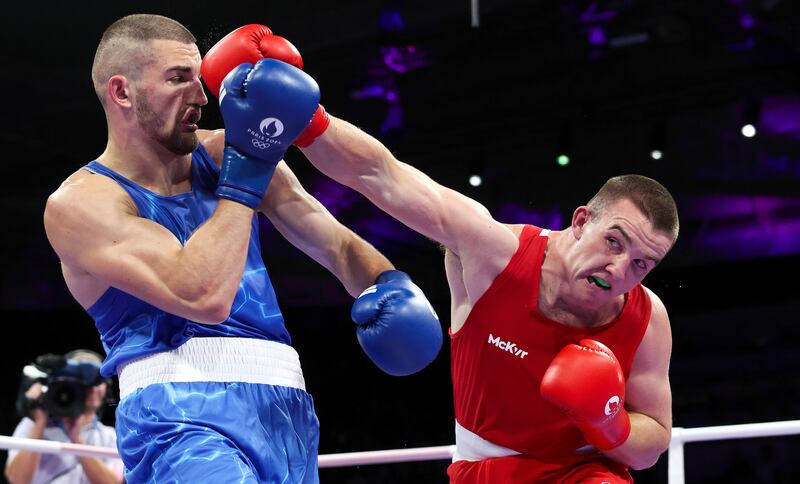 Ireland’s Jack Marley (red) lands a punch on Mateusz Bereznicki of Poland in the round of 16 92kg division; Marley won his bout.
Photograph: Ryan Byrne/Inpho