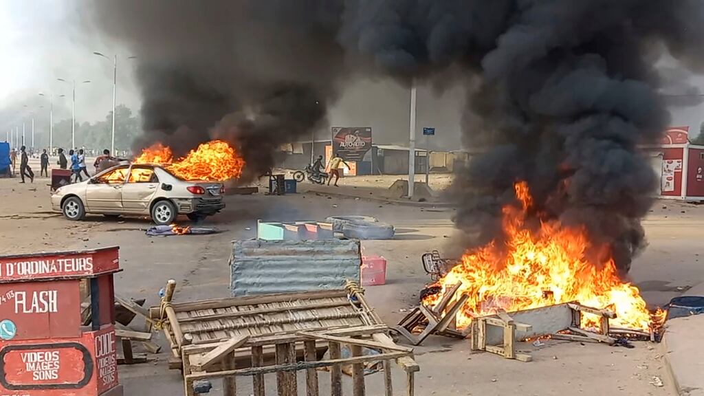 Cars burn during Thursday’s unrest which was said to be  unprecedented in Chad