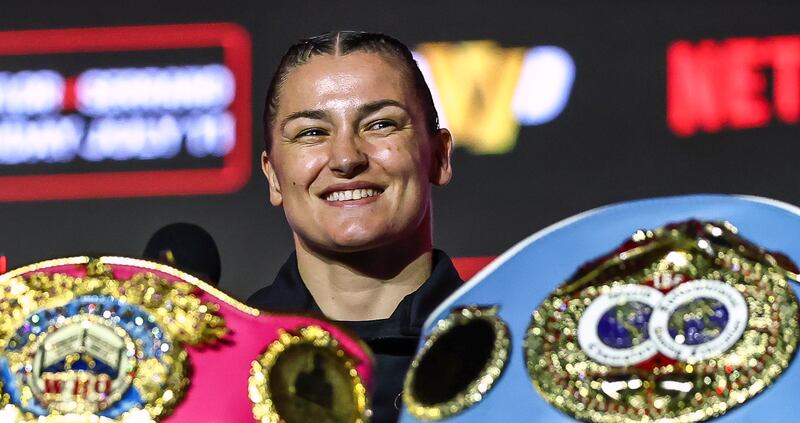 Katie Taylor at the press conference with her belts. Photograph: Inpho/Gary Carr