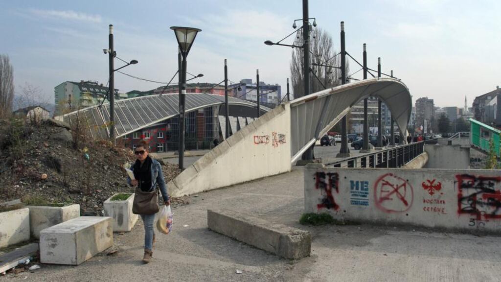 A Kosovar Serb woman crosses Mitrovica bridge, which serves as a link between the northern and southern part of the ethnically divided town of Mitrovica. Kosovo and Serbia have signed a number of agreements in key areas as a step towards normalising ties. Photograph: EPA
