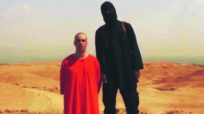 Captive: James Foley with one of his captors in the Islamic State video