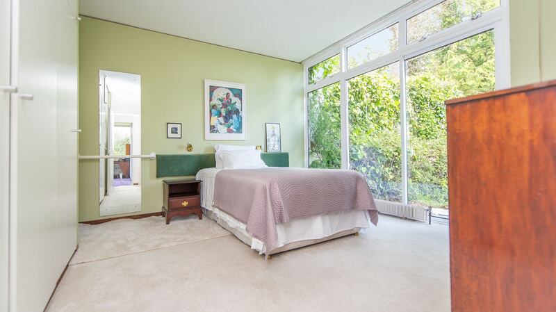 The main bedroom with glass doors leading to the private terrace