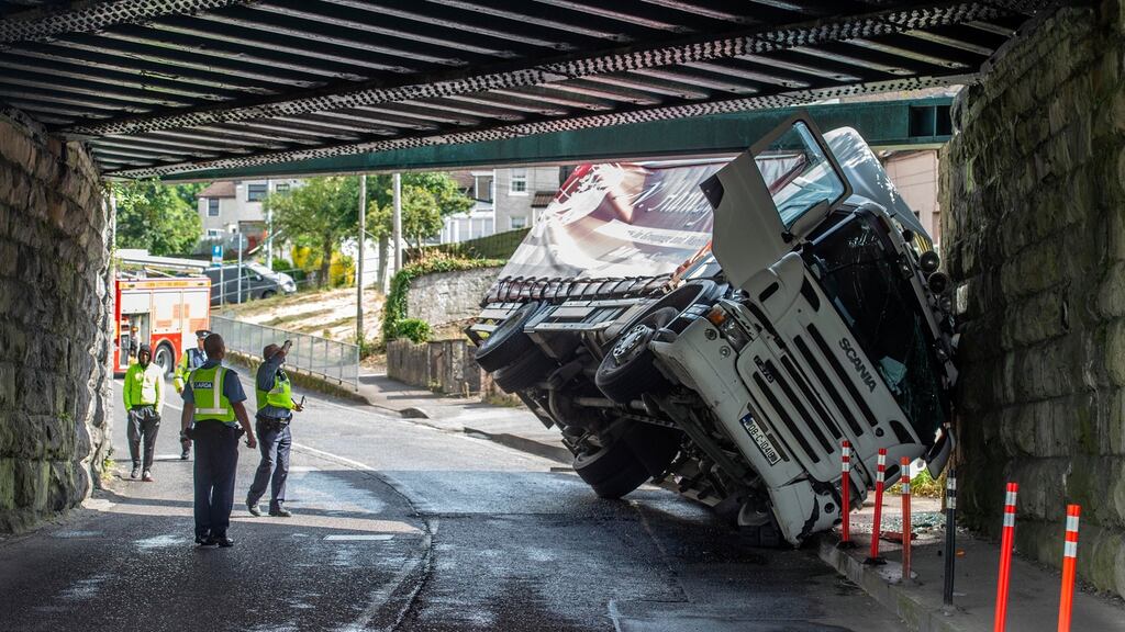 A truck which struck a railway bridge lies trapped at Dublin Hill, Cork city today. Photograph: Michael Mac Sweeney/Provision