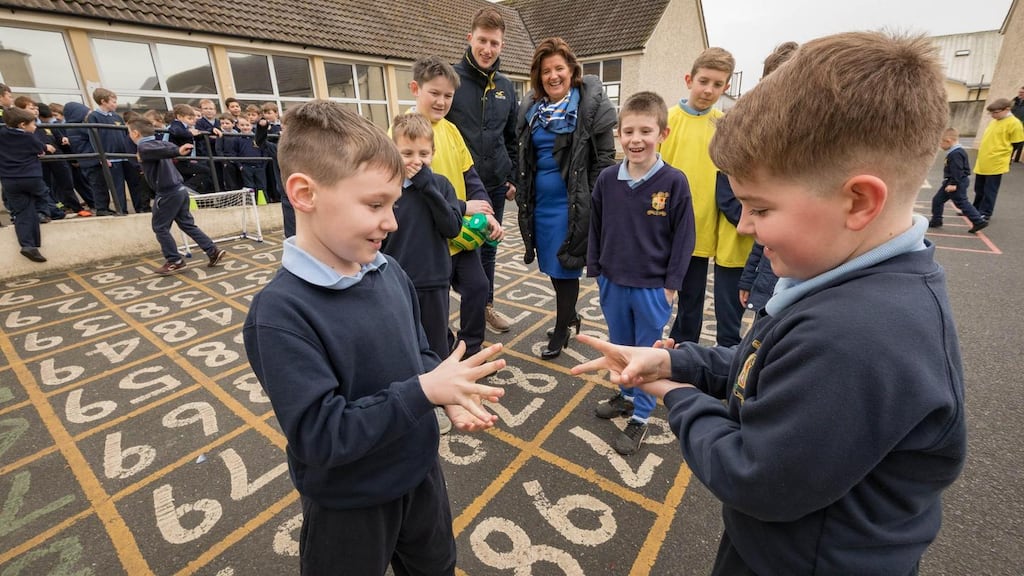 Tadhg Nolan and Jack Smith use “ro-sham-bo” (rock-paper-scissors) as a dispute resolver, watched by other students and principal Regina Doheny and teacher Cian Mullaly at Scoil Phádraig Naofa, Tullow, Co Carlow. Photograph: Dylan Vaughan