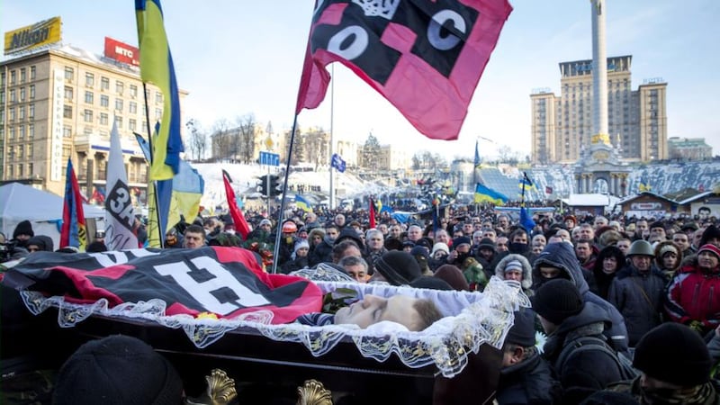 Anti-government protestors carry the body of Mikhail Zhiznevsky, 25, a protestor killed during clashes with police on Wednesday, through Independence Square today in Kiev, Ukraine. Photograph: Rob Stothard/Getty Images