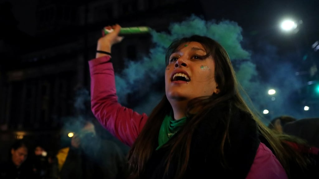An abortion rights activist holds a flare outside the Congress after senators rejected a bill to legalise abortion, in Buenos Aires, on Thursday. Photograph: Marcos Brindicci/Reuters