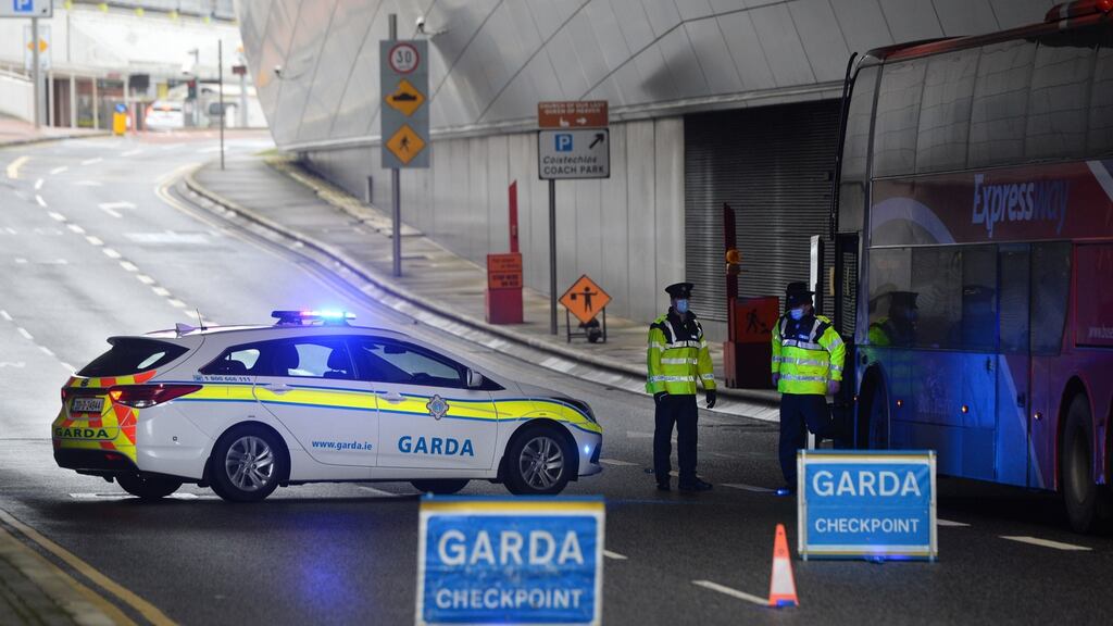 A Garda steps off a bus at a checkpoint in Dublin Airport during Covid-19 lockdown in late January, 2021. Photograph: Dara Mac Dónaill / The Irish Times