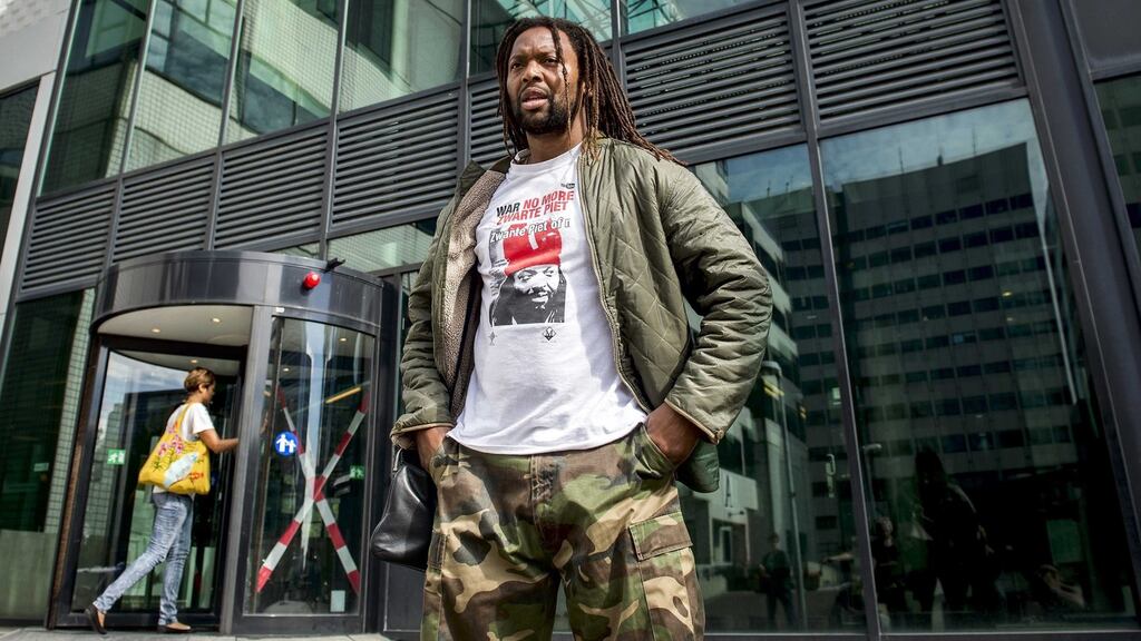 A demonstrator wearing a shirt with ‘No more Zwarte Piet’ in front of the court house in Amsterdam. The court decided that Amsterdam has to reconsider the traditional move-in Sinterklaas event. The traditional figure Zwarte Piet (Black Pete) is the companion of Saint Nicolas during a yearly feast celebrated on the evening of December 5th. Photograph: Remko De Wall/EPA