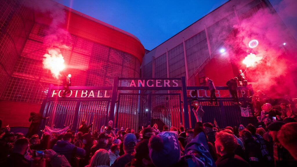 Rangers fans outside Ibrox after their side’s win on Saturday. Rangers were confirmed as champions when Celtic drew with Dundee United on Sunday. Photo: Jane Barlow/PA Wire