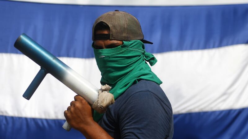 A member of the April 19 movement holding a hand-made mortar. Photograph: Marvin Recinos / AFP/ Getty Images