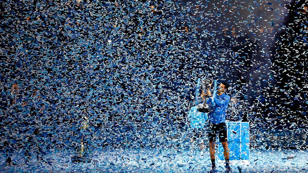 Novak Djokovic lifts the trophy following his victory during the men’s singles final against Roger Federer at the Barclays ATP World Tour Finals. Photograph: Julian Finney/Getty Images