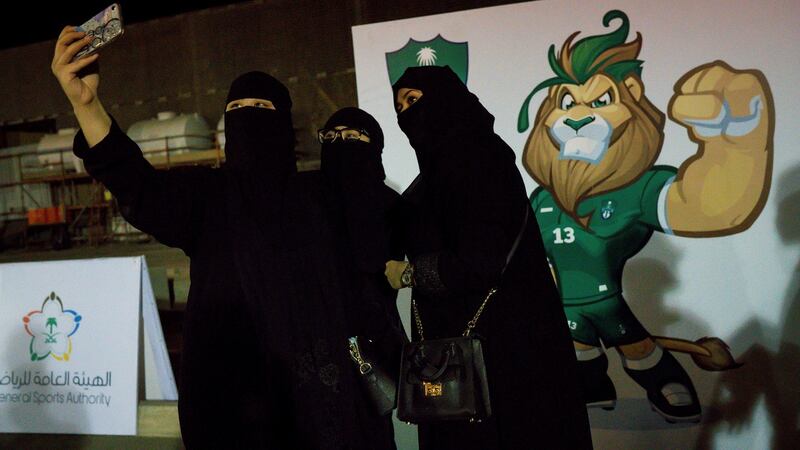 Women take a photograph outside the match between local rivals Al-Ahli and Al-Batin in Jeddah, Saudi Arabia, on Friday. Photograph: Tasneem Alsultan/The New York Times