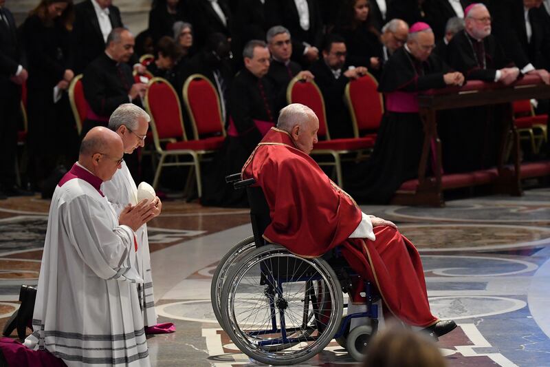Pope Francis, seated in a wheelchair, prays as he presides over the Passion of the Lord mass on Good Friday at St Peter's Basilica in The Vatican. Photograph: Tiziana Fabi/AFP/Getty Images
