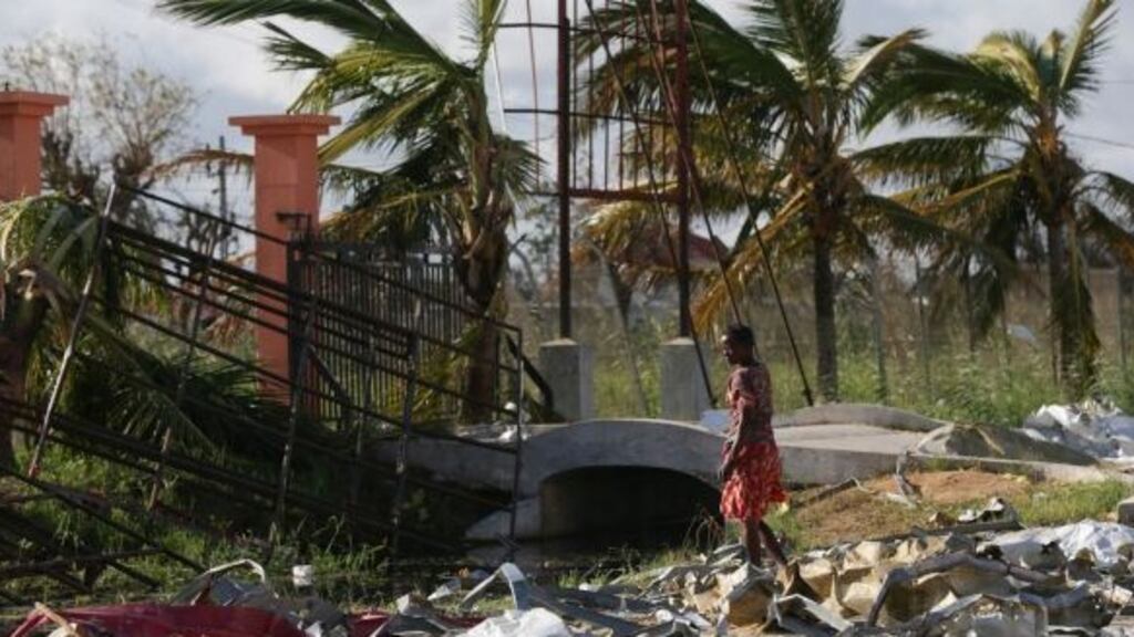 A woman searches for materials to rebuild her home after the passage of Cyclone Idai, in Beira City, central Mozambique in 2019. Extreme weather events are expected to become more regular due to climate change. Photograph: Tiago Petinga/EPA