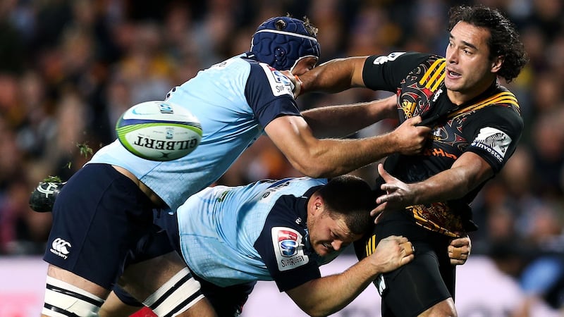 James Lowe of the Chiefs offloads in the tackle against Waratahs’ Tom Robertson and Dean Mumm at Waikato Stadium in Hamilton, New Zealand. Photograph: Hagen Hopkins/Getty Images