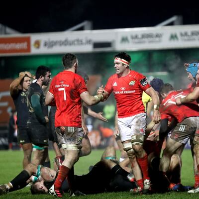 On the pitch: Billy Holland celebates a Munster win over Connacht with team-mate Peter O’Mahony. Photograph: Bryan Keane/Inpho