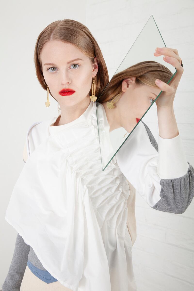 White ruched top €190, panelled engineered trouser with neon trim €195, brass earring Soko, Atrium €79, ring Soko Atrium €89