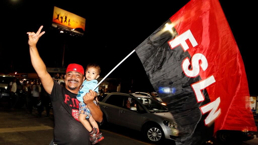 A supporter of Nicaragua’s president Daniel Ortega holds up a flag of the Sandinista National Liberation Front (FSLN) after elections in Managua, Nicaragua. Photograph: Oswaldo Rivas/Reuters