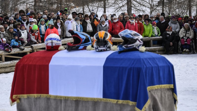 Helmets are placed on the flag-draped coffin of Poisson as people attend a ceremony in his memory in Peisey-Nancroix, in the French Alps. Photo: Phillipe Demasz/Getty Images