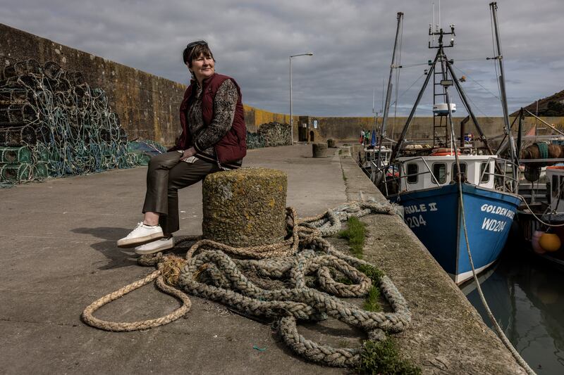 Caitlín Uí Aodha, a fishing vessel owner and skipper, at the pier near her home in Helvick. Photograph: Finbarr O'Reilly/New York Times