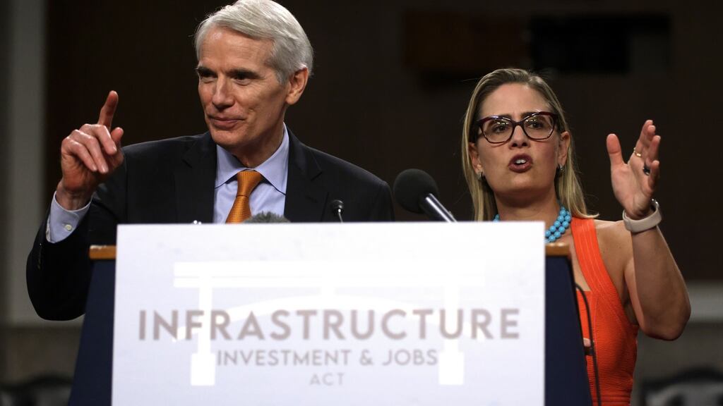 US Repbulican senator Rob Portman  and Democrat senator Kyrsten Sinema  answer questions  after a procedural vote for the bipartisan infrastructure framework  on Capitol Hill in Washington, DC on July 28th. Photograph: Alex Wong/Getty