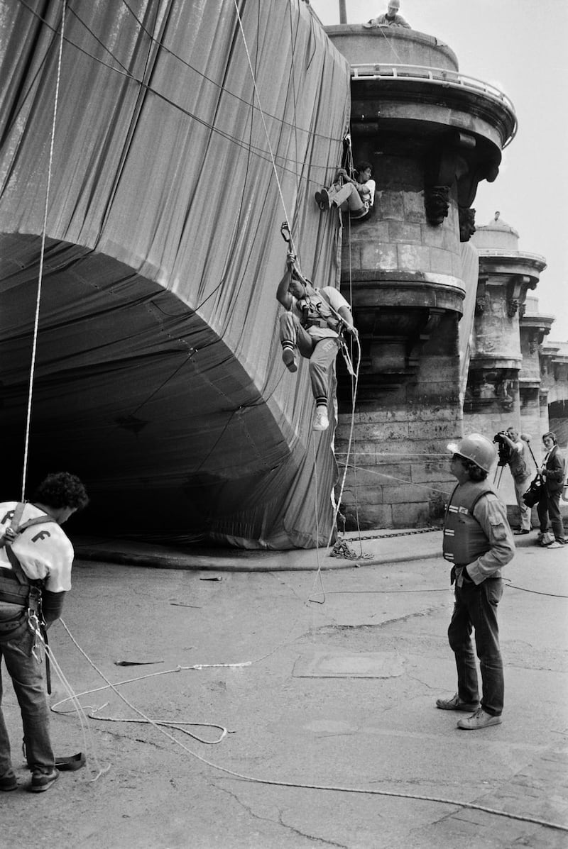 Christo and Jeanne-Claude: the artist watch Pont Neuf, in Paris, being wrapped in 1985. Photograph: Pierre Guillaud/AFP via Getty