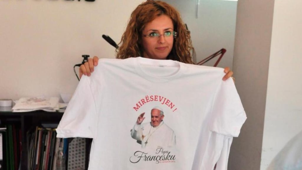 A woman holds a T-shirts bearing an image of Pope Francis and the word ‘Welcome’ a shop in Shkoder in Albania. Photograph: EPA/STR