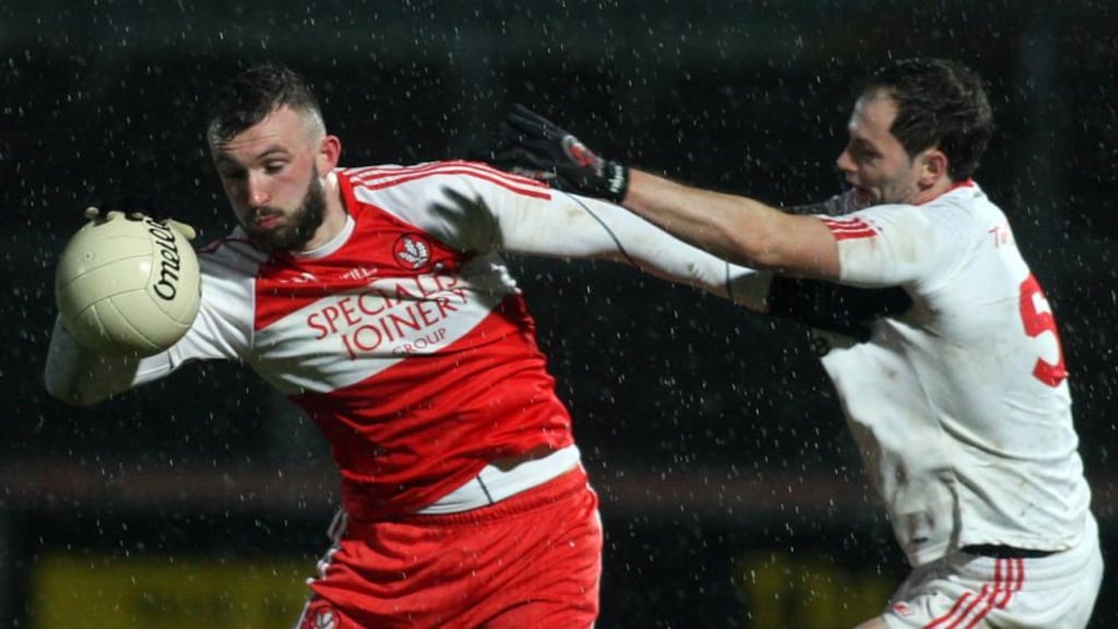 Derry’s Terence O’Brien shields the ball from Tyrone’s Ronan McNabb. Photo: Doherty/Inpho