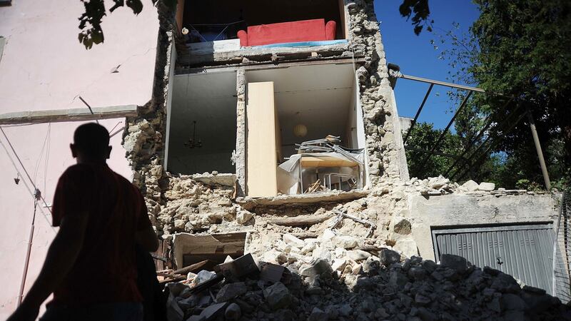 A man looks at a destroyed building in Accumoli on Wedneday after a strong earthquake hit central Italy, leaving at least 38 people dead and dozens more injured, trapped or missing. Photograph: Marco Seppetell/AFP/Getty Images.