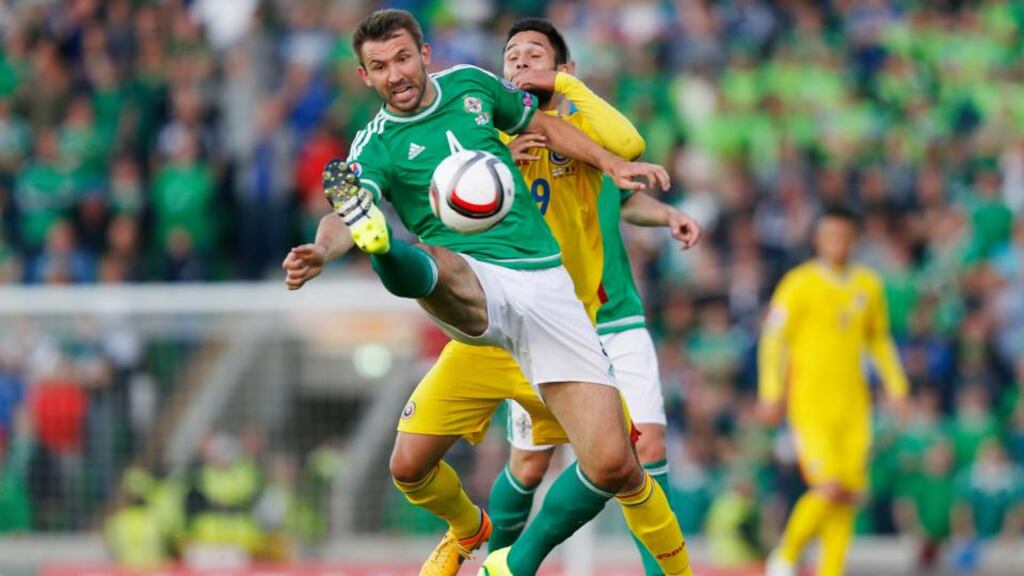 Northern Ireland’s Gareth McAuley in action with Romania’s Florin Andone during the Euro 2016 Group F qualifier at Windsor Park. Photo: Peter Cziborra/Action Images via Reuters/Livepic