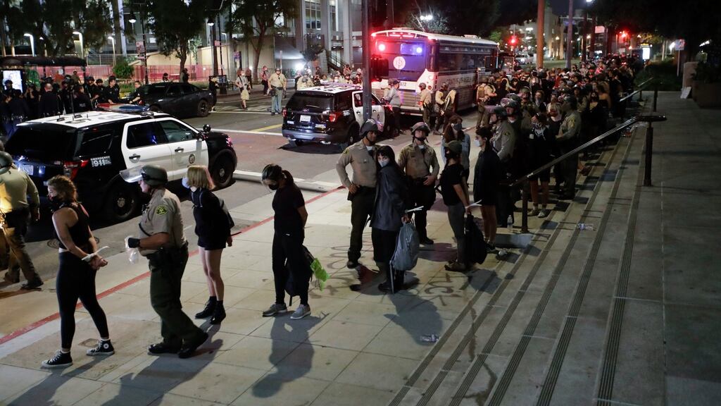 Demonstrators over the death of George Floyd are arrested for a curfew violation in Los Angeles on Wednesday. Photograph: Marcio Jose Sanchez/AP