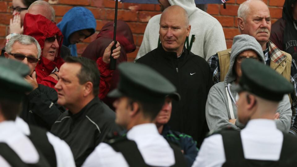 Progressive Unionist Party (PUP) leader Billy Hutchinson (second right in black top) watches on as an Orange Order parade makes its way down Crumlin Road adjacent to the nationalist Ardoyne neighbourhood. Photograph: Brian Lawless/PA Wire
